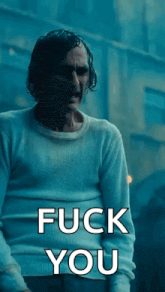 a man in a white sweater is saying " fuck you "