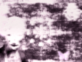 a black and white photo of a baby with a purple background