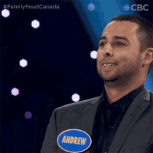 a man in a suit has a name tag that says andrew on it