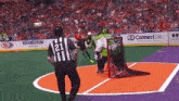 a hockey game is being played in a stadium with advertisements for connectlife and new amsterdam vodka