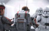 a group of stormtroopers are standing next to each other and talking to each other .