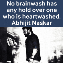 a man stands in front of a sign that says no brainwash has any hold over one who is heartwashed abhijit naskar