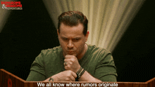 a man stands at a podium with the words we all know where rumors originate