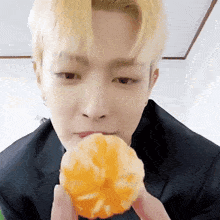 Kim Hongjoong Ateez Gif Hongjoong Eating A Tangerine Then Waving To The Camera GIF