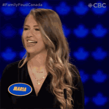 a woman with a name tag that says maria is smiling