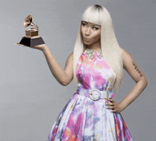a woman with a tattoo on her arm is holding a grammophone