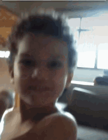 a close up of a child 's face in a room