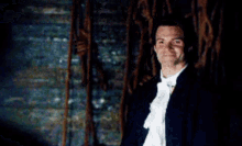 a blurry picture of a person standing in a dark room with smoke coming out of their mouth .