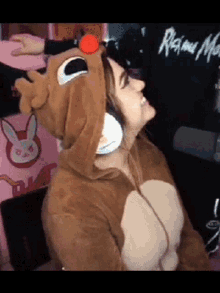 a woman in a reindeer costume is wearing headphones .
