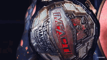 a close up of a wrestling belt that says impact