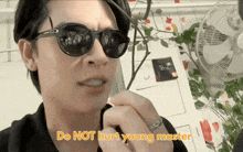 a man wearing sunglasses says " do not hurt young master " in yellow letters
