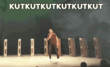 a man is running on a stage with the words " kutkutkutkutkut " written above him
