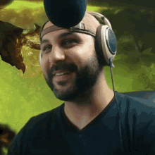 a man wearing headphones and a hat is smiling