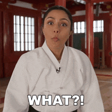 a woman in a karate uniform says what in black