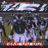 a group of football players are walking on a field with the words wake up boy written on the bottom .