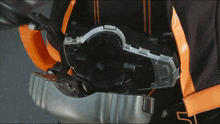 a person is wearing a black and orange outfit and has a device on their back that says ' samurai ' on it