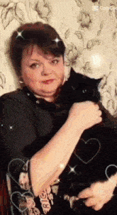 a woman is holding a black cat in her arms with hearts around her and the word cop cut in the corner