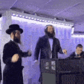 a group of jewish men are dancing in a room