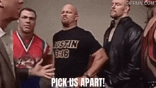a group of wrestlers are standing next to each other and one of them is wearing a shirt that says justin 316