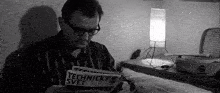a man in glasses is reading a magazine called technicky svet