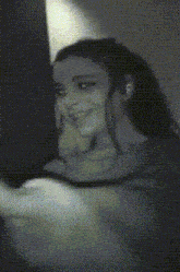 a black and white photo of a woman taking a picture of herself