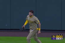 a baseball player wearing a san diego jersey stands on a field