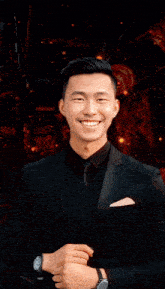 a man in a suit and tie stands in front of a sign that says " dj undercover "