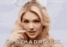 a woman is pointing at her face and saying `` i 'm such a dirty girl `` .