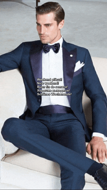 a man in a tuxedo sits on a couch