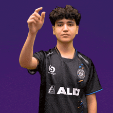 a young man wearing a black shirt that says aldi