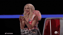 a woman in a fairy costume is clapping her hands while sitting in a car .