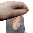 a hand is holding a picture of a girl .