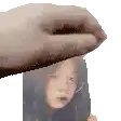 a hand is holding a picture of a girl .