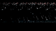 a group of soldiers are standing in a line in a dark room