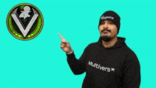 a man wearing a black hoodie that says multivers is pointing
