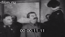 a black and white photo of a man with a mustache and a time of 11:11