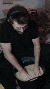 a man wearing headphones is kneading rice