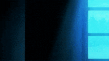 a blue light is coming through a window in a dark room .
