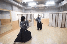 two men are fighting with swords in a room with a sign on the wall that says ' samurai '