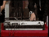 a person wearing a watch is playing a keyboard on a table