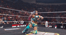 a woman in a wrestling ring with a sign that says prime in the background