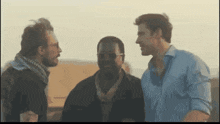 three men are standing next to each other and one of them is wearing sunglasses
