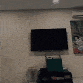 a painting of a woman reading a newspaper is above a flat screen tv