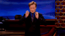 Conan O Brien Hand Eyeglasses GIF - Conan O Brien Hand Eyeglasses Change Outfit GIFs