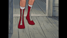 a person wearing red boots and white socks