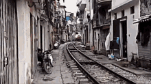 A Train In Hanoi, Vietnam Makes A Daily Close Encounter For Some Residents. GIF - Train Railway Slums GIFs