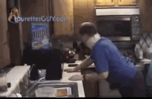 a man is standing in a kitchen with a bag of total on the counter