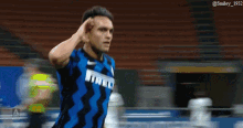 a soccer player wearing a blue and black jersey that says irelli on it