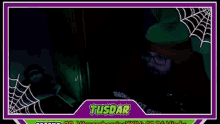 a man in a red hoodie and glasses is sitting in a dark room with a spider web in the background .