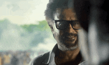 a man with glasses and a beard is looking at another man